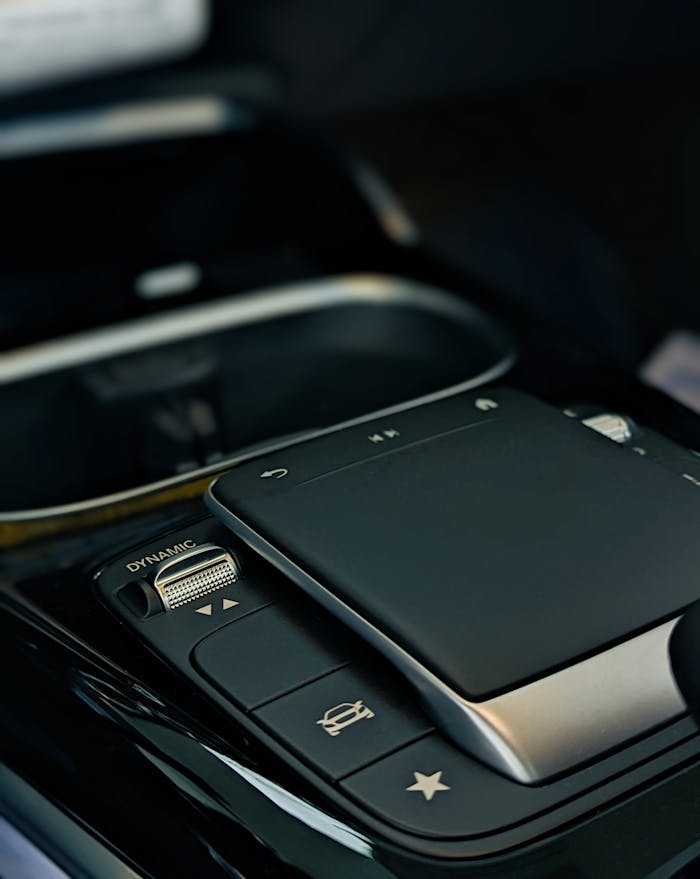 pexels-photo-13452549 Detailed image of a sleek modern car control panel with touchpad and control buttons.