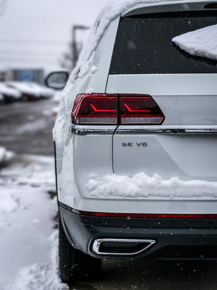 pexels-photo-13473311 Close-up of a snow-covered SUV parked outdoors in winter.