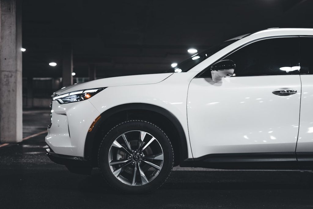 pexels-photo-19410440 A stylish white SUV parked in an urban garage showcasing modern luxury design elements.